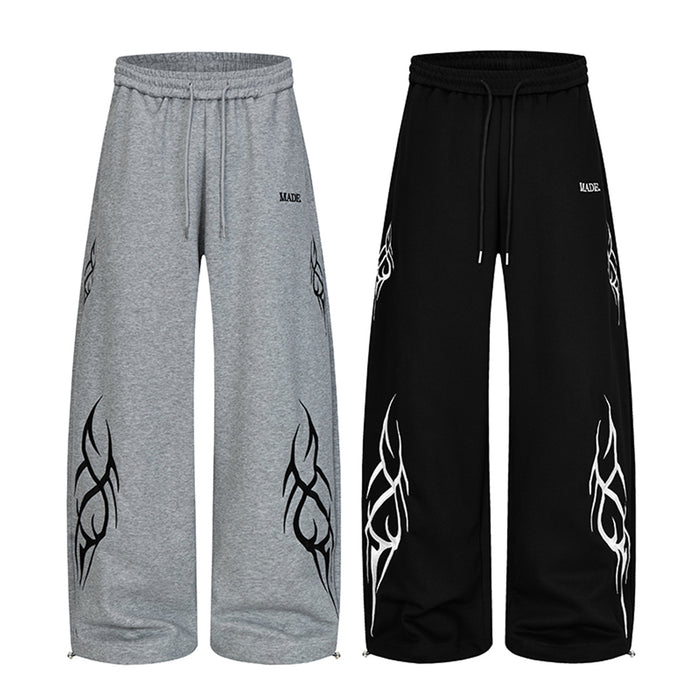 Wide-leg sweatpants with tribal flame print on both legs, drawstring waist, shown in black and heather grey