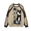 Beige sweatshirt front with a black-and-white tuxedo cat, music notes, and dark brown raglan sleeves