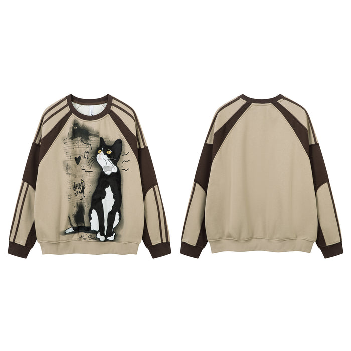 Beige sweatshirt shown from front and back with tuxedo cat graphic and brown colorblock sleeves