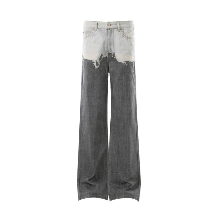 Front view of two-tone distressed wide-leg jeans with light wash waist and dark gray legs