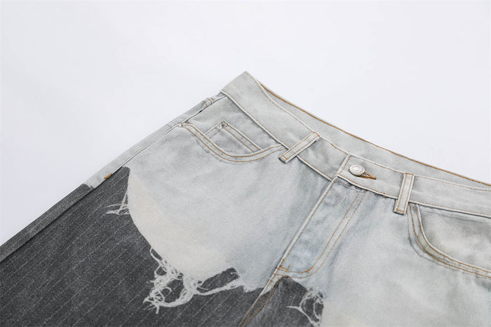 Close-up of front waistband and pocket on light wash and dark gray distressed jeans
