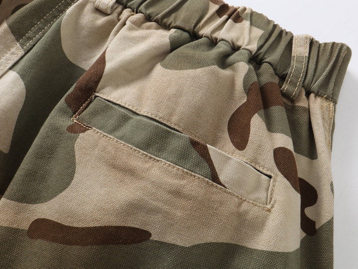 Close-up of camouflage pants back pocket with stitched opening and elastic waist