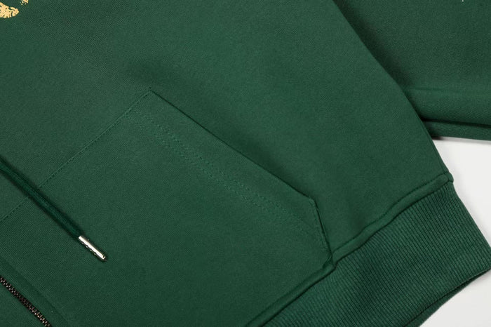 Close-up of dark green hoodie pocket and ribbed cuff