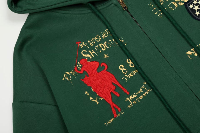 Close-up of dark green hoodie front graphic with red rider and distressed lettering