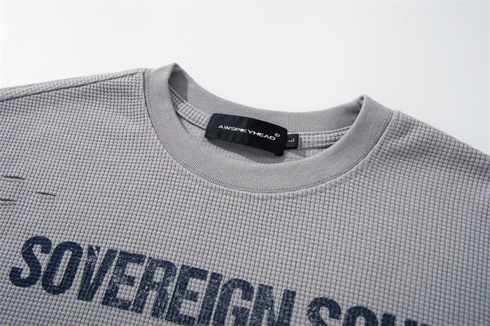 Close-up of light gray waffle knit T-shirt collar and Sovereign Soul print
