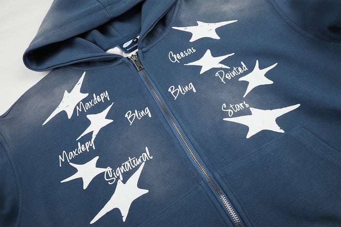 Close-up of the blue hoodie front showing white star graphics, printed words, and metal zipper