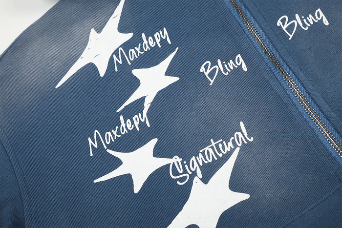 Close-up of white star prints and handwritten-style lettering on the blue hoodie front