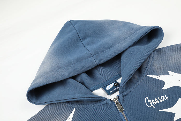 Close-up of the blue hoodie showing the hood, front zipper, and sewn-in neck label
