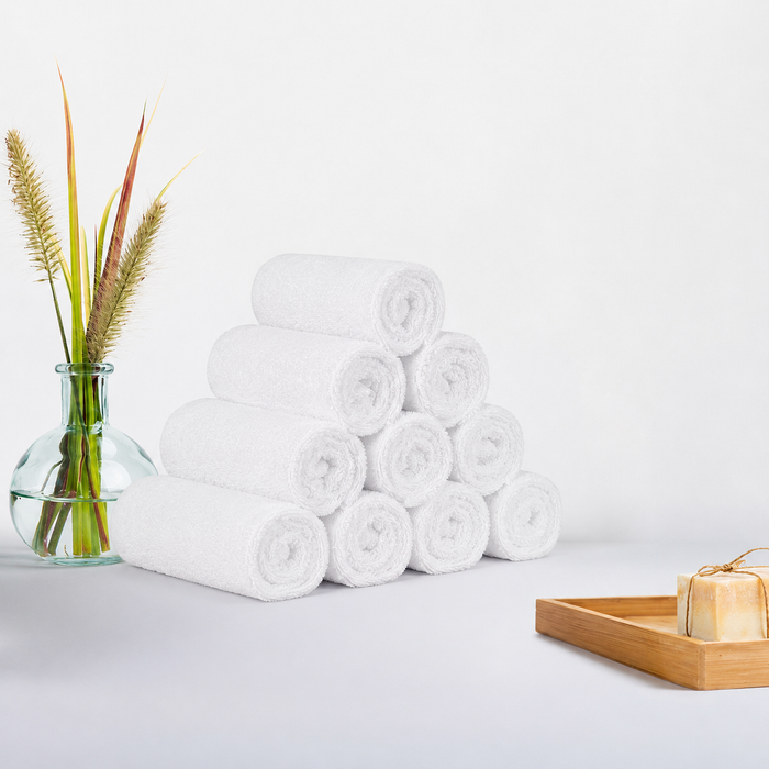 White cotton towel set arranged in a hotel bathroom