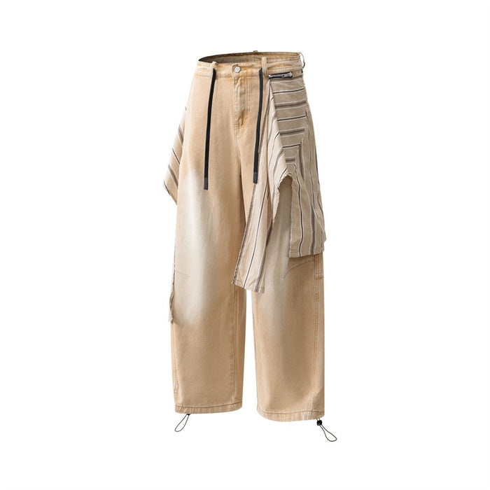 Angled front view of tan baggy jeans showing the striped overlay and zippered pocket