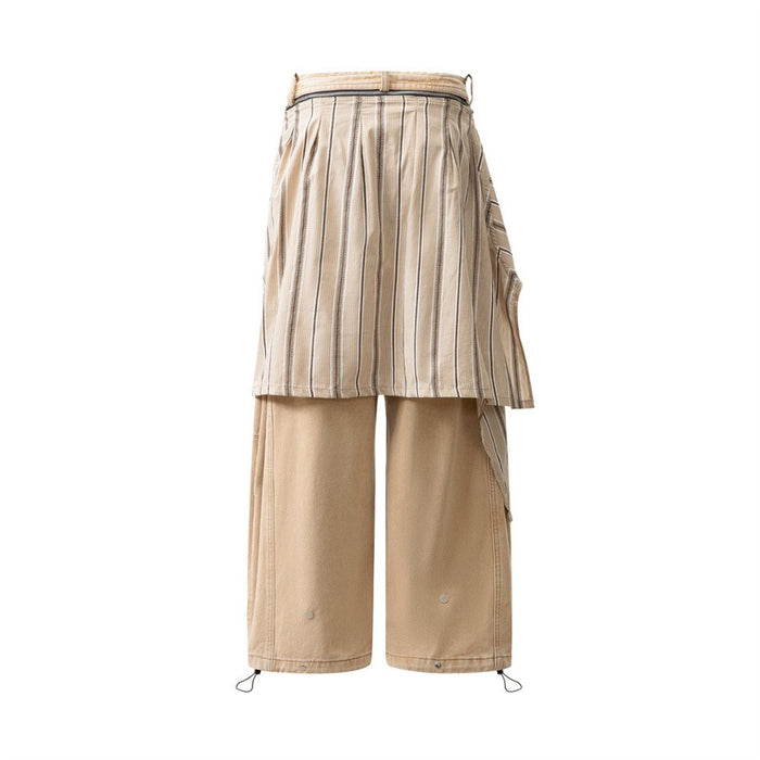 Back view of tan wide-leg jeans covered by a vertically striped skirt overlay
