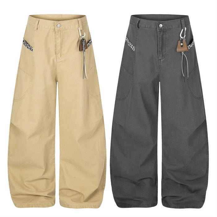 Wide-leg baggy pants in charcoal grey with curved hem, leopard-print pocket trim, and carabiner clip waistband detail