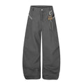 Charcoal wide-leg pants with leopard trim, curved hems, and carabiner detail, front view