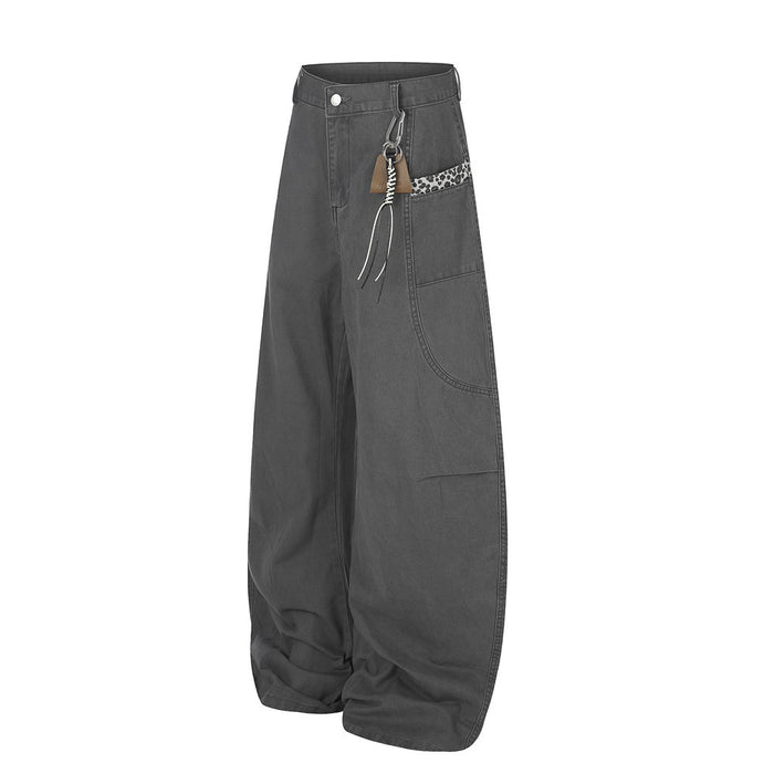 Charcoal wide-leg pants with leopard trim and carabiner detail, angled front view
