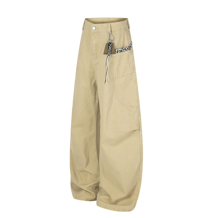 Beige wide-leg pants with leopard trim and carabiner detail, angled front view