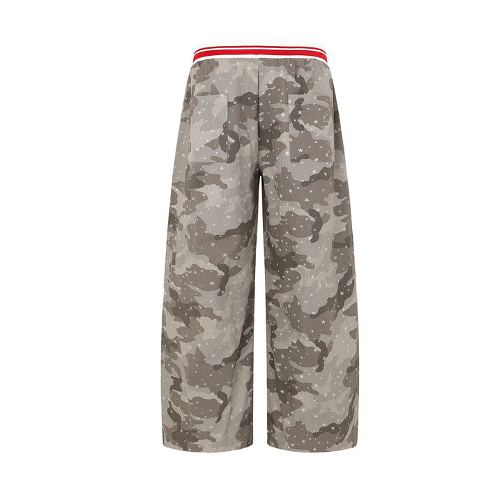 Back view of wide-leg gray camouflage pants featuring scattered white stars and a red-striped waistband