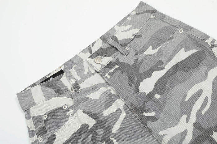 Close-up of the grey camouflage pants waistband, belt loops, button closure, and front pockets