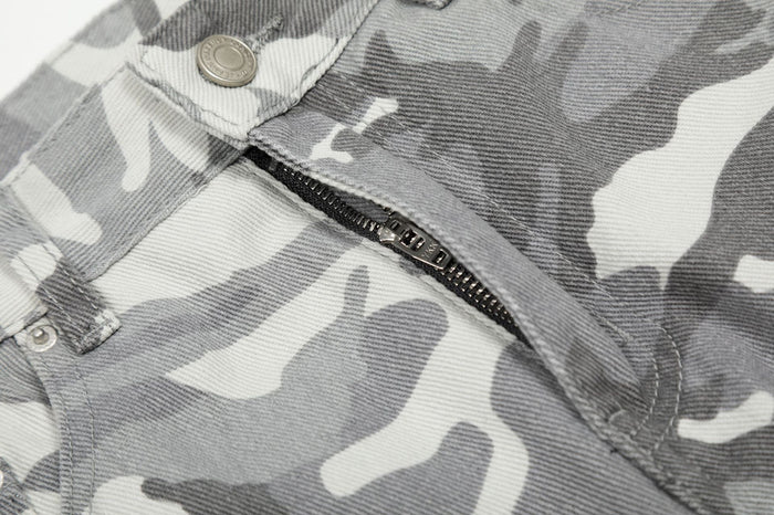 Close-up of the grey camouflage pants front zipper, metal button, and stitched waistband detail