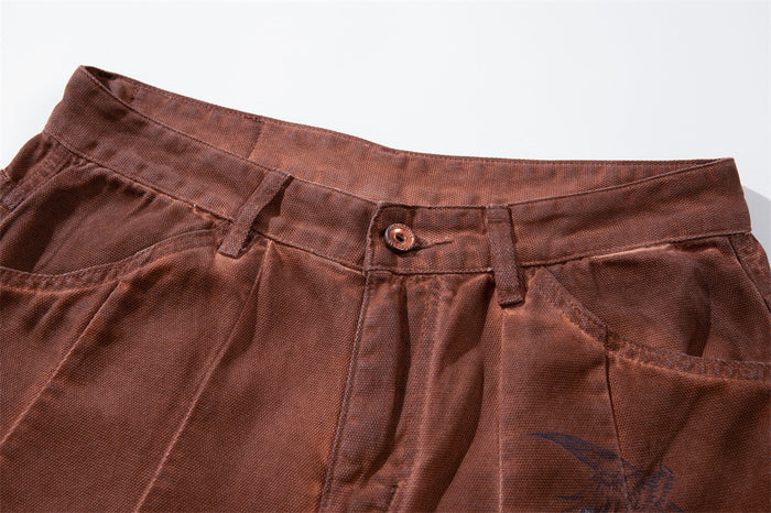 Close-up of brown waistband with button, belt loops, and front pockets