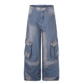 Wide-leg washed denim cargo pants with multi snap-button thigh pockets in faded blue, front view