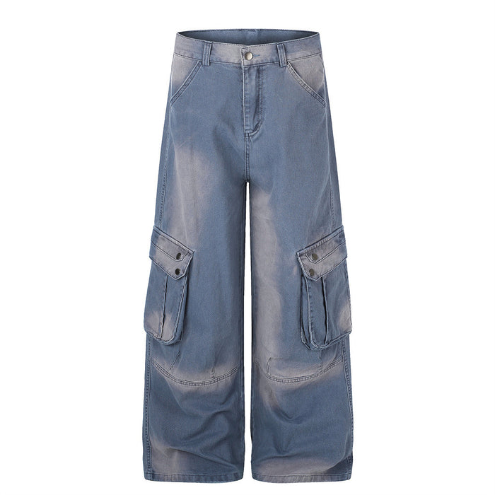 Wide-leg washed denim cargo pants with multi snap-button thigh pockets in faded blue, front view