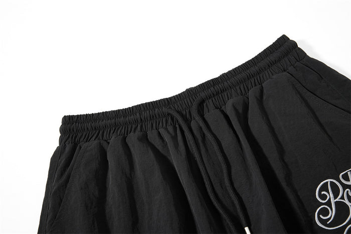 Close-up of black elastic waistband and drawstring on wide-leg cargo sweatpants