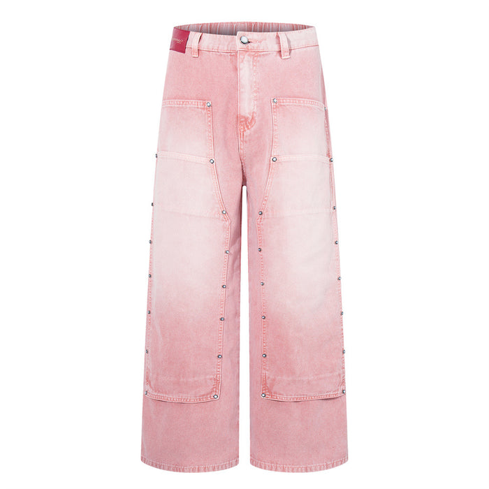 Flat lay front view of pink washed wide-leg carpenter jeans with large patch pockets and studs