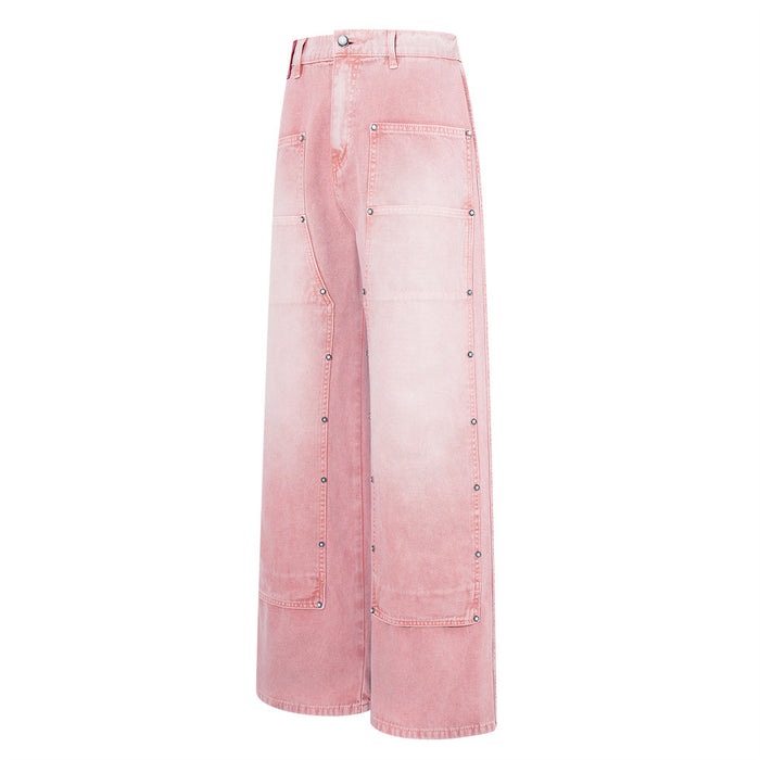 Angled side view of pink washed wide-leg carpenter jeans with studded patch pockets