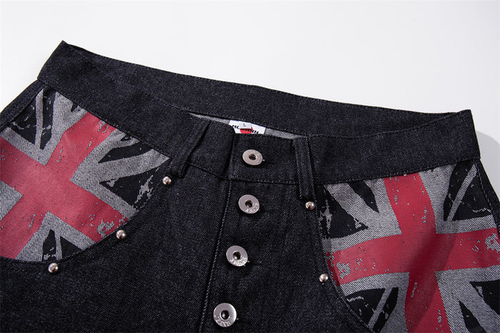 Close-up of waistband and button fly on dark denim jeans with Union Jack pocket trim
