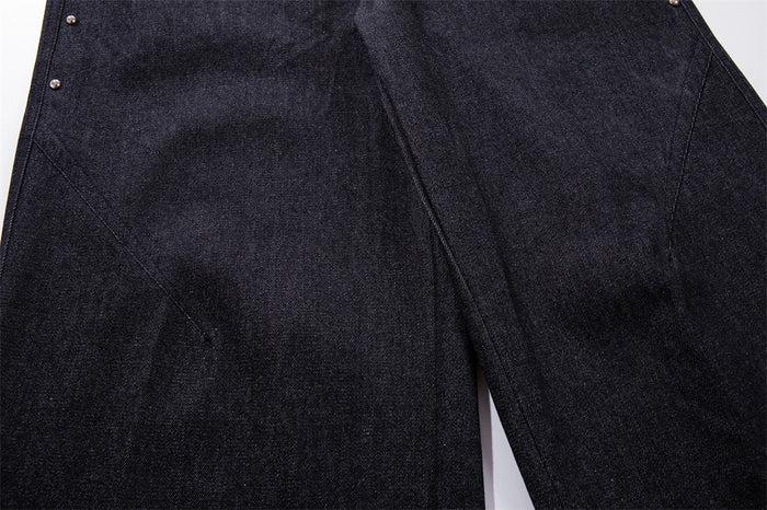 Close-up of wide-leg dark denim fabric with seam detail on the front leg
