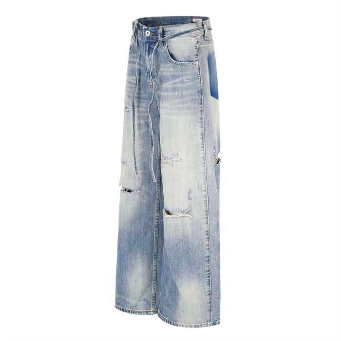 Side view of wide-leg gradient washed jeans with ripped details