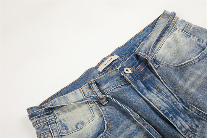 Top waist detail of gradient washed denim jeans with belt loops and button fly