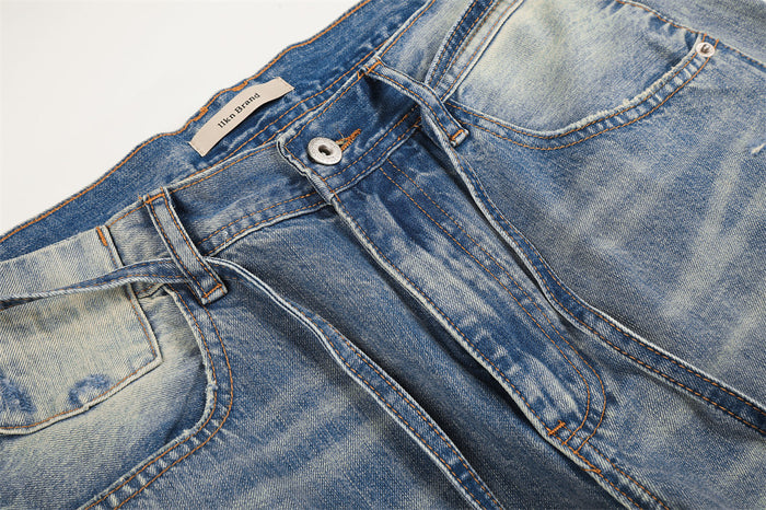 Close-up of front waistband and pocket area on faded blue jeans