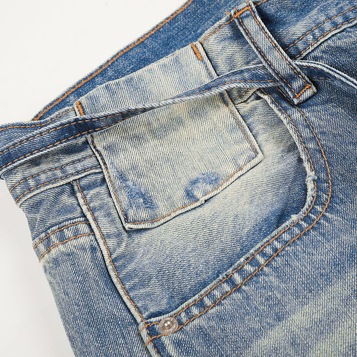 Back pocket close-up on gradient washed denim jeans with topstitching