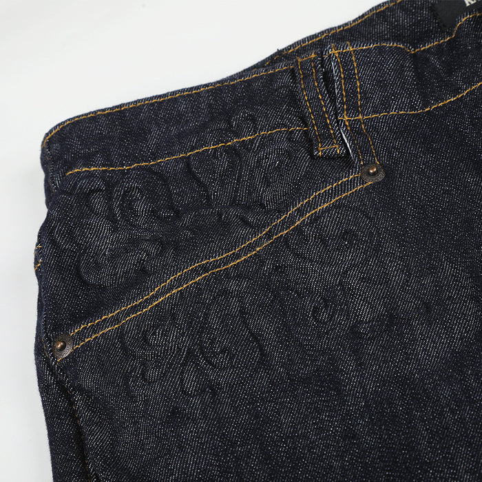 Close-up of front pocket area with embossed floral detail and contrast stitching