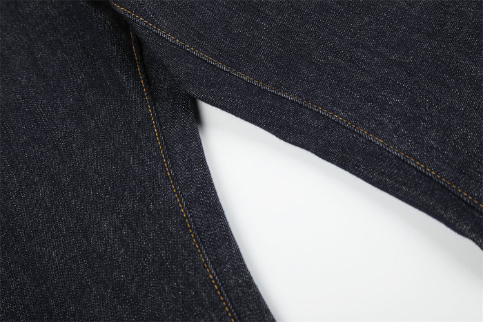 Close-up of jean leg seam on dark indigo denim