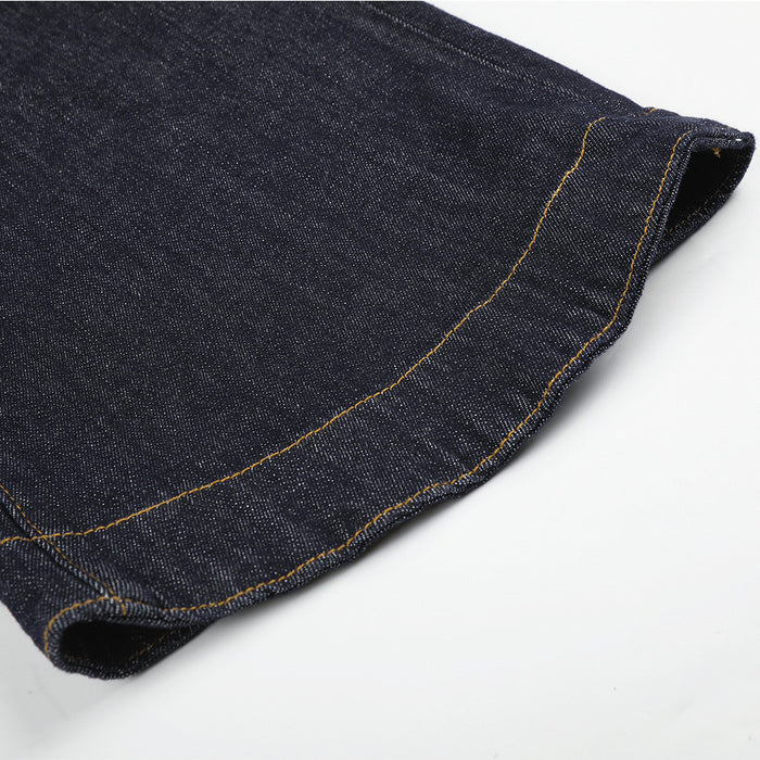 Close-up of wide hem on dark indigo jeans with contrast stitching