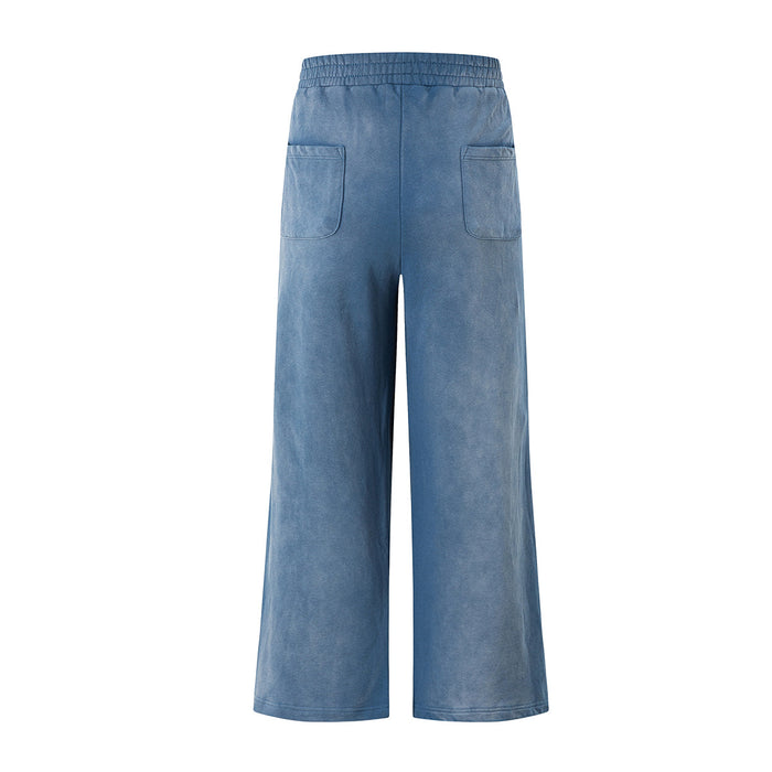 Back view of blue acid-wash wide-leg sweatpants with an elastic waistband and two patch pockets