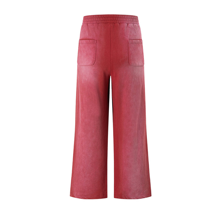 Back view of pink acid-wash wide-leg sweatpants with an elastic waistband and two patch pockets