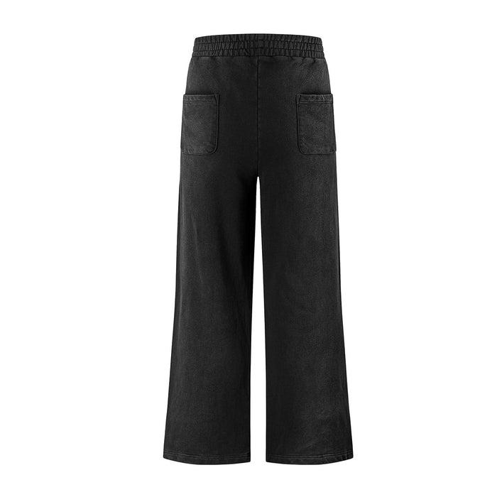 Back view of black acid-wash wide-leg sweatpants with an elastic waistband and two patch pockets