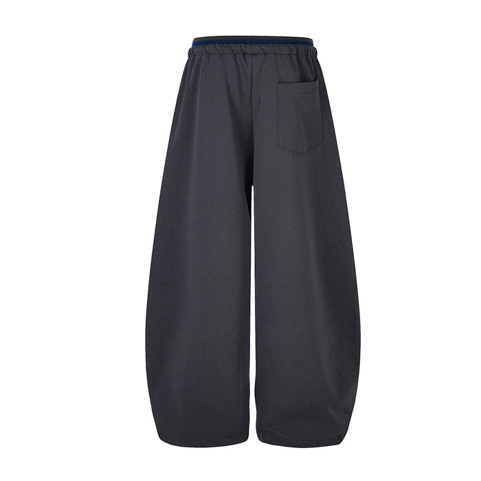 Back view of charcoal wide-leg sweatpants showing the rear patch pocket and elastic waistband
