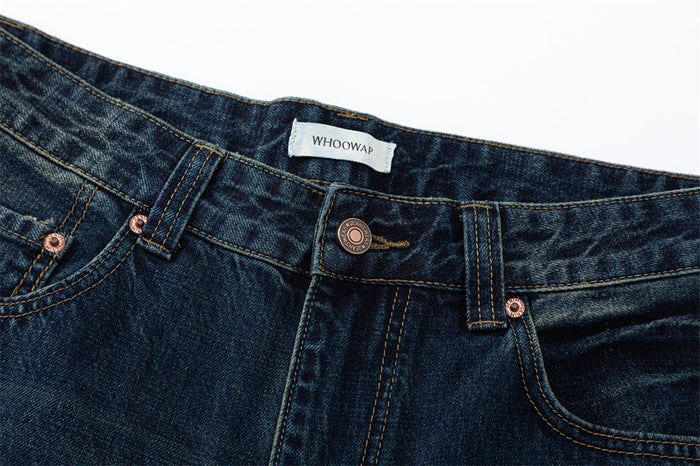 Close-up of front waistband with button, belt loop, coin pocket, and brand label
