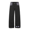 Black wide-leg jeans with argyle patchwork waistband and embroidered hem detail, front view