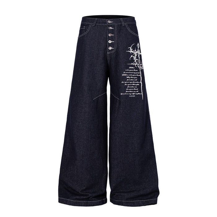 Dark indigo wide-leg jeans front view with button fly and white Gothic cross script embroidery