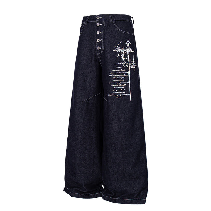 Dark indigo wide-leg jeans angled front view with button fly and white cross script embroidery
