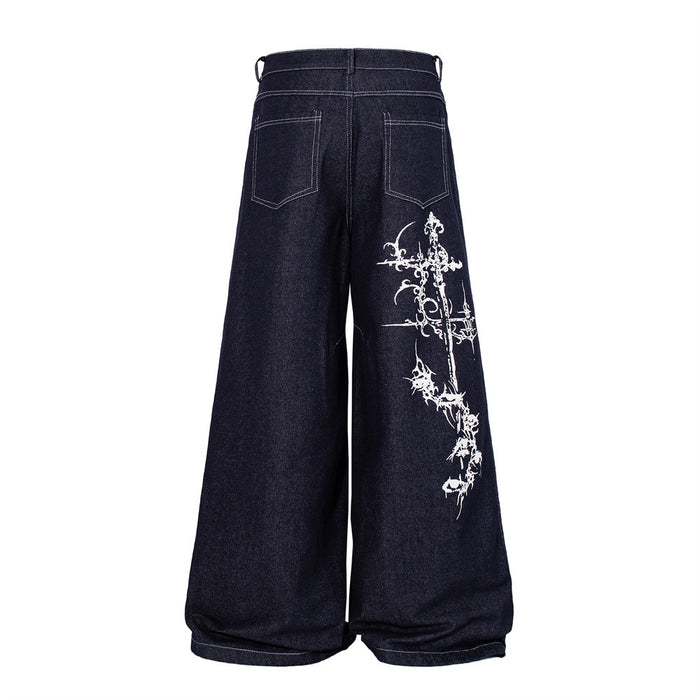 Back view of dark indigo wide-leg jeans with white Gothic cross embroidery on the right leg
