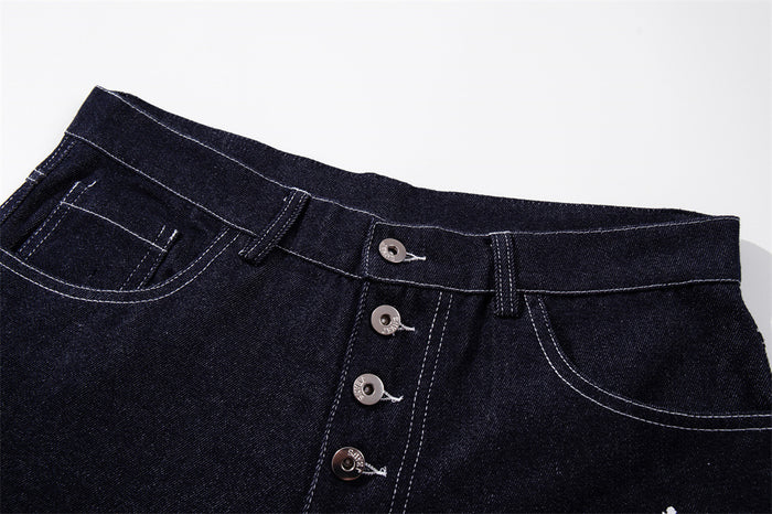 Close-up of dark indigo jeans waistband and button fly with contrast stitching
