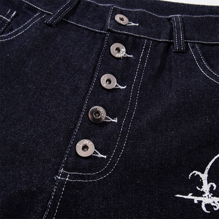 Close-up of five-button fly on dark indigo jeans with visible topstitching