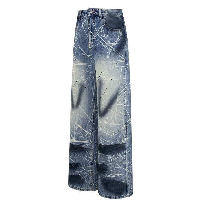 Side view of blue wide-leg jeans with white scratch print and dark wash panels