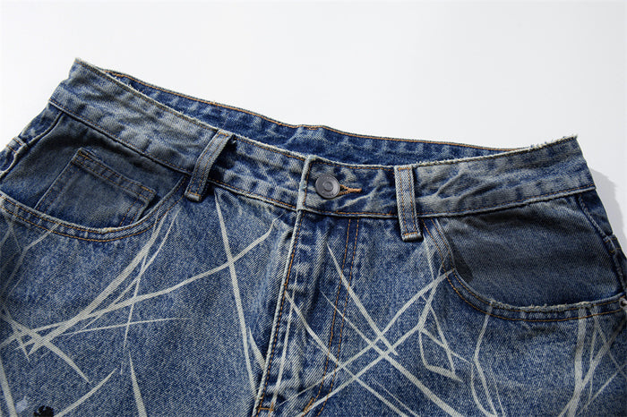 Close-up of waistband and front pocket on blue jeans with scratch print